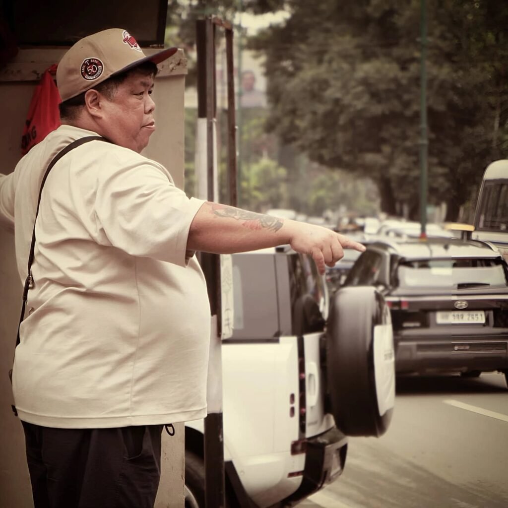 Jamyang Kalsang founder of Kalsang Restaurant in beige shirt and cap