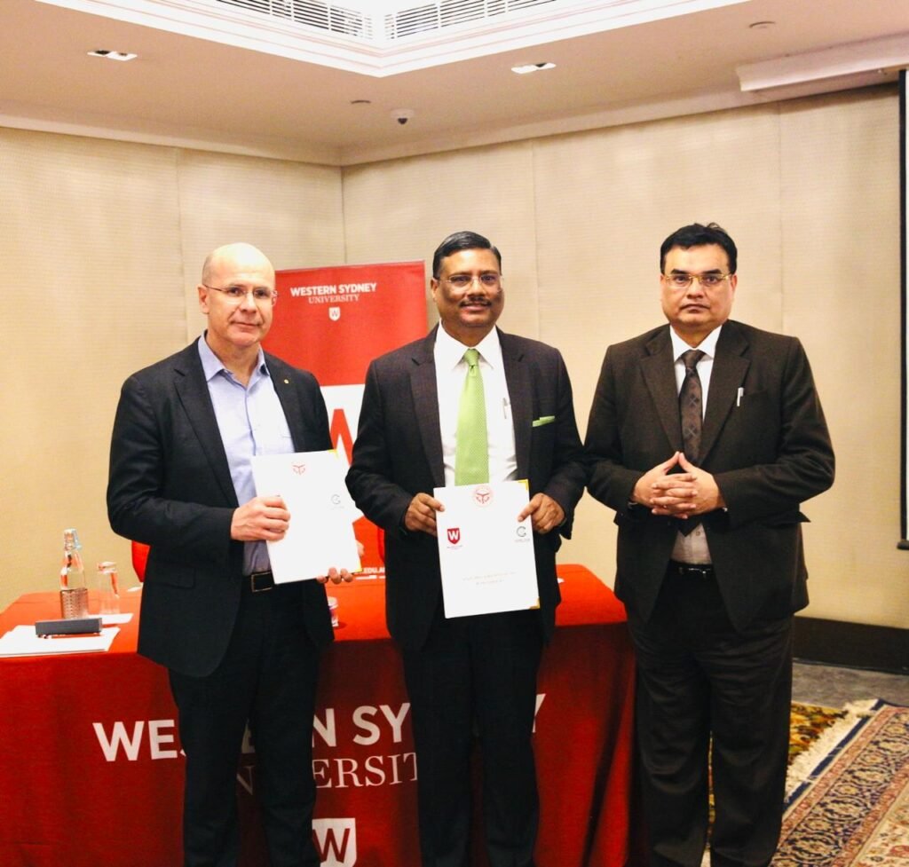 Western Sydney University and GNIDA representatives holding signed partnership documents for the Greater Noida campus
