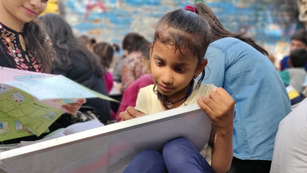 A student focusing on her studies at a Pehchaan The Street School classroom session