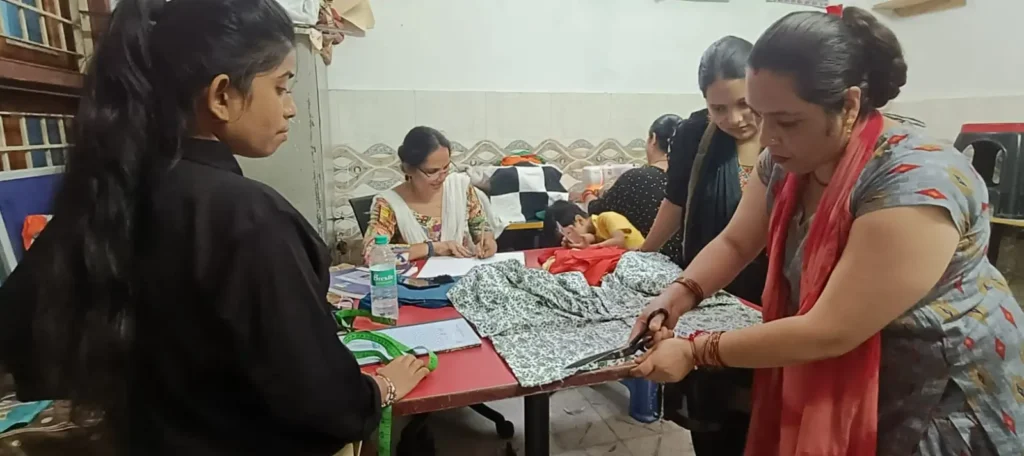 Cloth cutting demonstration during stitching training at SADRAG SARTHAK centre in Noida