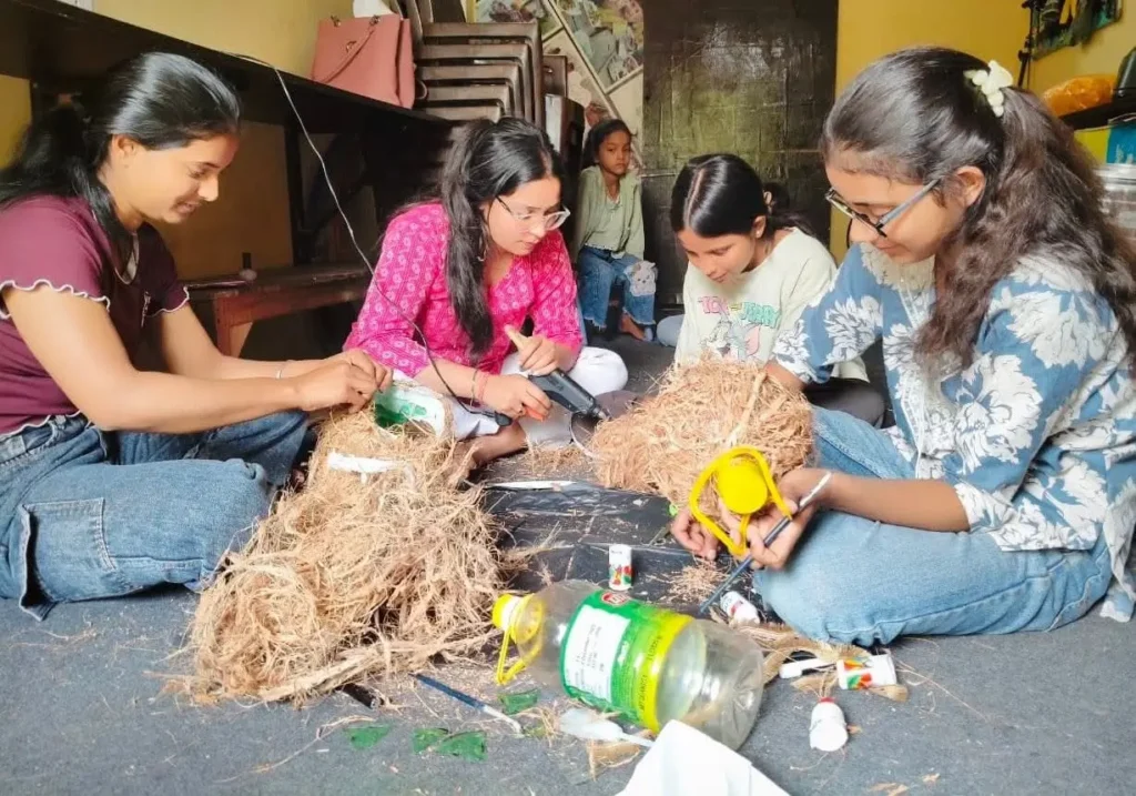 Students make bird shelters and feeders using reused plastic containers and jute in Noida