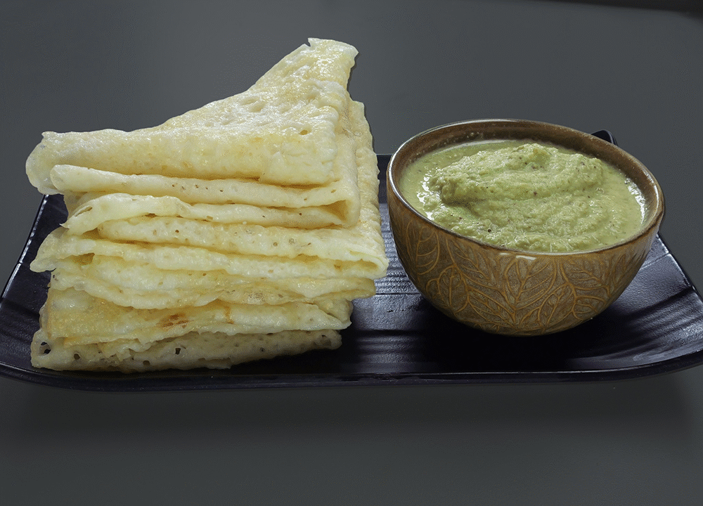 Stack of Neer dosa with coconut chutney in a bowl, Nisha Madhulika signature South Indian breakfast recipe