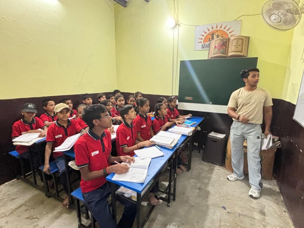 Children attending evening remedial classes at UshaKiran Study Center, Noida, with volunteer educators, supported by partner foundations.