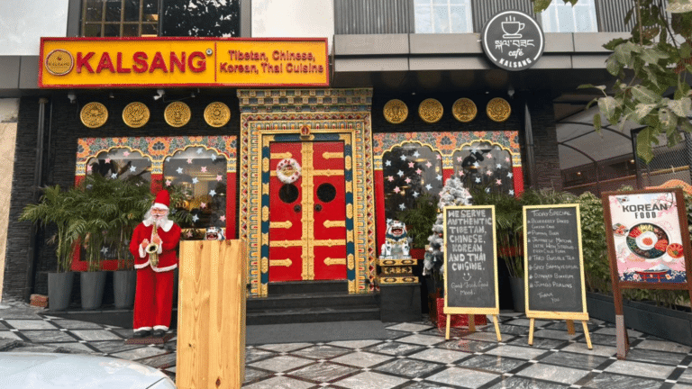 Kalsang Restaurant storefront with red Tibetan doors, yellow signage and gold Buddhist circles
