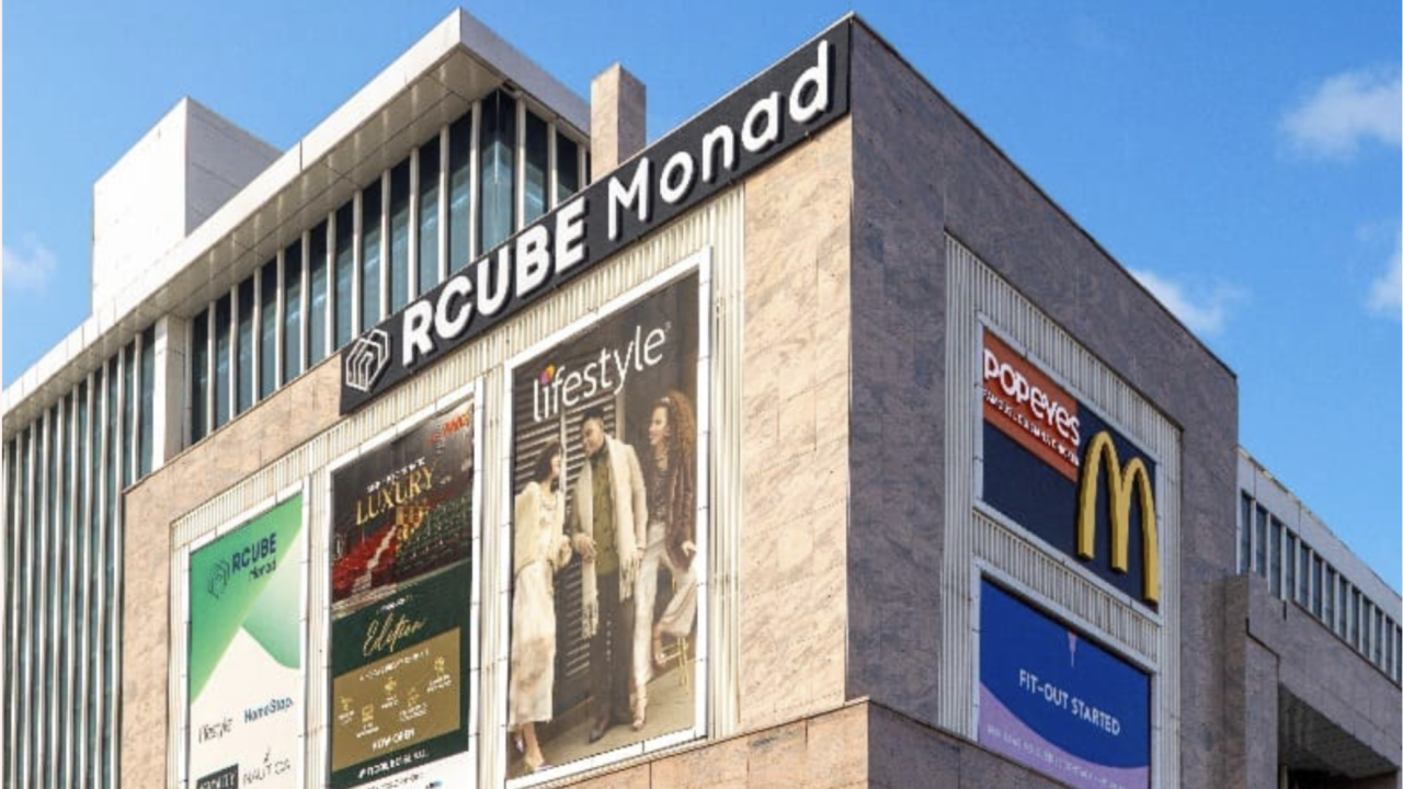 RCube Monad Mall exterior in Sector 43 Noida with brand hoardings for Lifestyle, Popeyes and McDonald’s.
