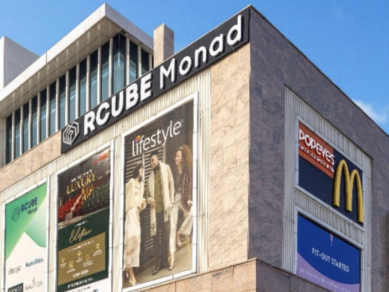 RCube Monad Mall exterior in Sector 43 Noida with brand hoardings for Lifestyle, Popeyes and McDonald’s.