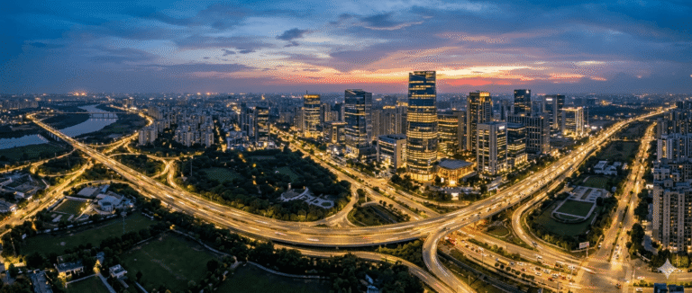 Aerial skyline view of Noida’s modern business district and expressways at dusk, showing the city’s rapid infrastructure and technology-driven growth.