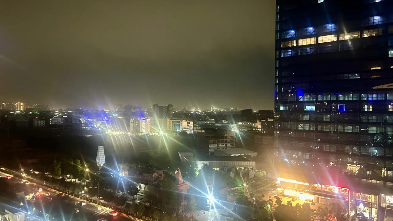 Noida city skyline at night under heavy storm clouds on May 28 2026 ahead of IMD thunderstorm and rain alert