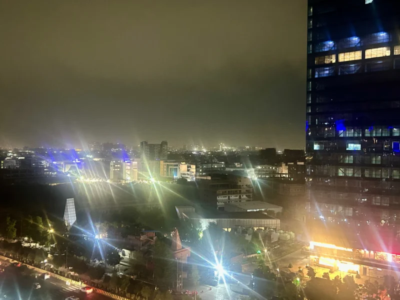 Noida city skyline at night under heavy storm clouds on May 28 2026 ahead of IMD thunderstorm and rain alert