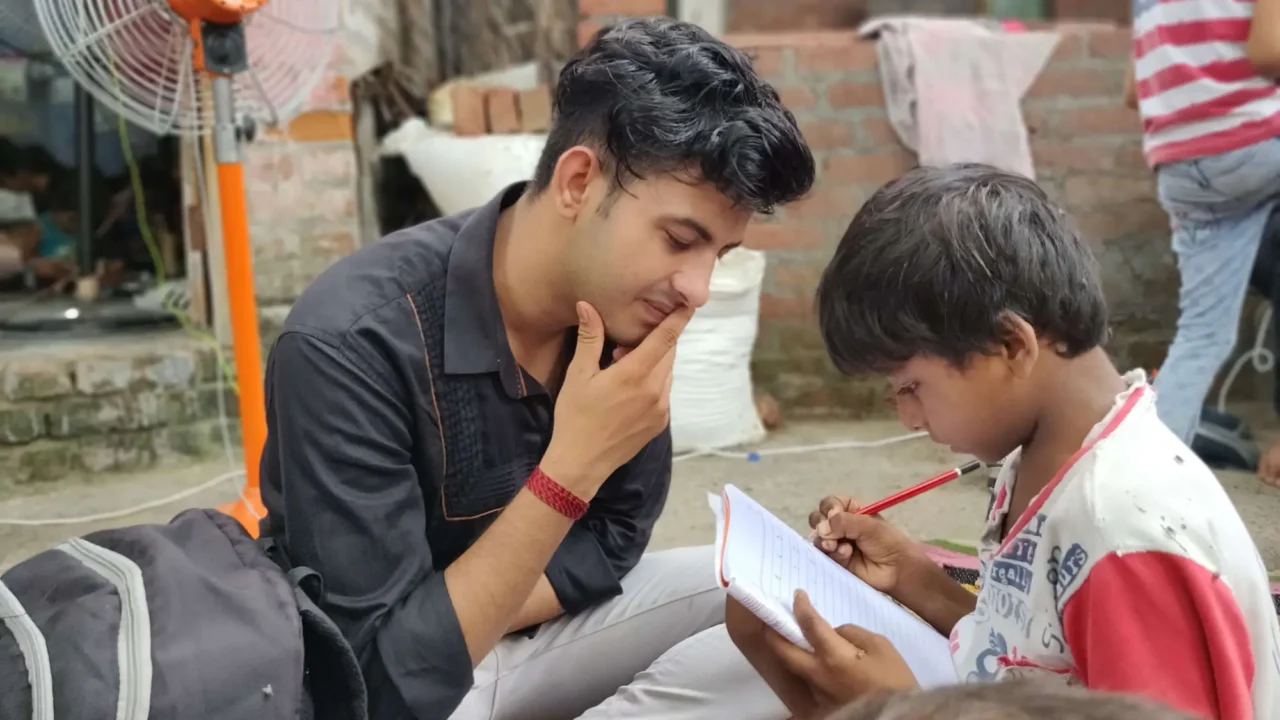 A Pehchaan The Street School volunteer helps a child during a learning session