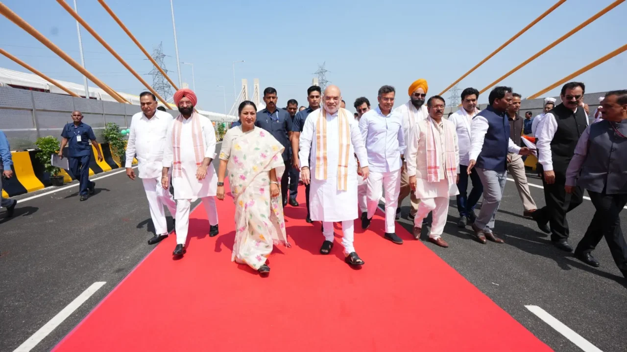 Amit Shah and other officials walking on a cable-stayed bridge during the Delhi road-project inauguration