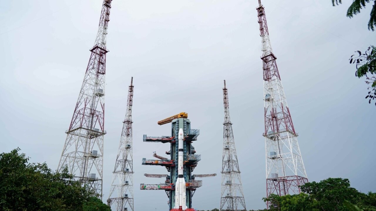 ISRO's GSLV-F18 rocket carrying the NVS-03 NavIC navigation satellite at the Sriharikota launch pad, surrounded by four lightning protection towers.